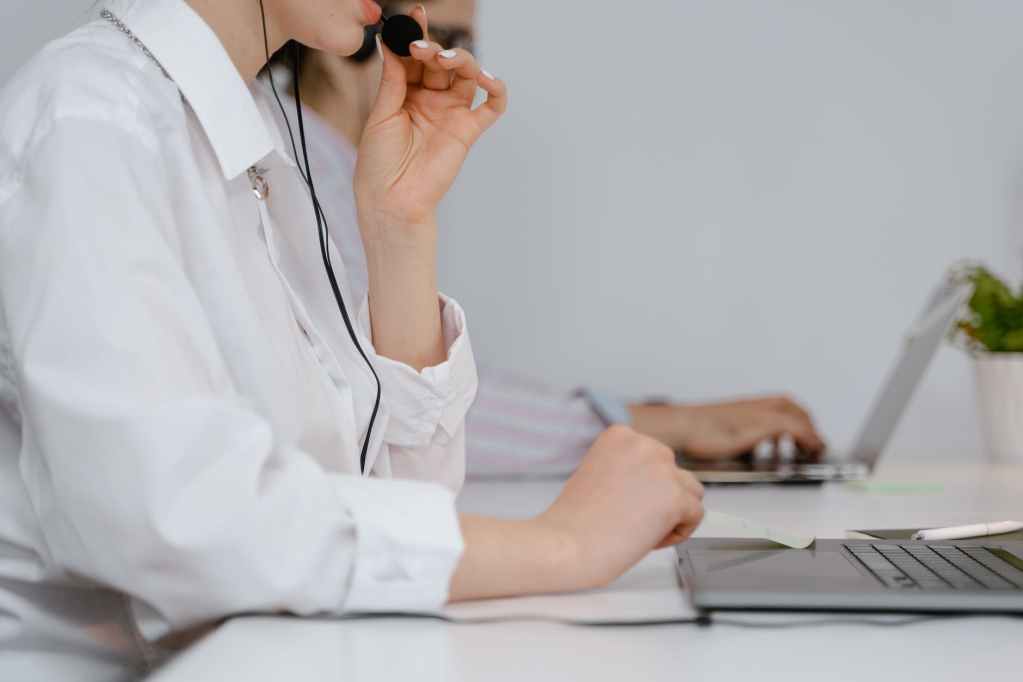 a woman talking on a headset while working